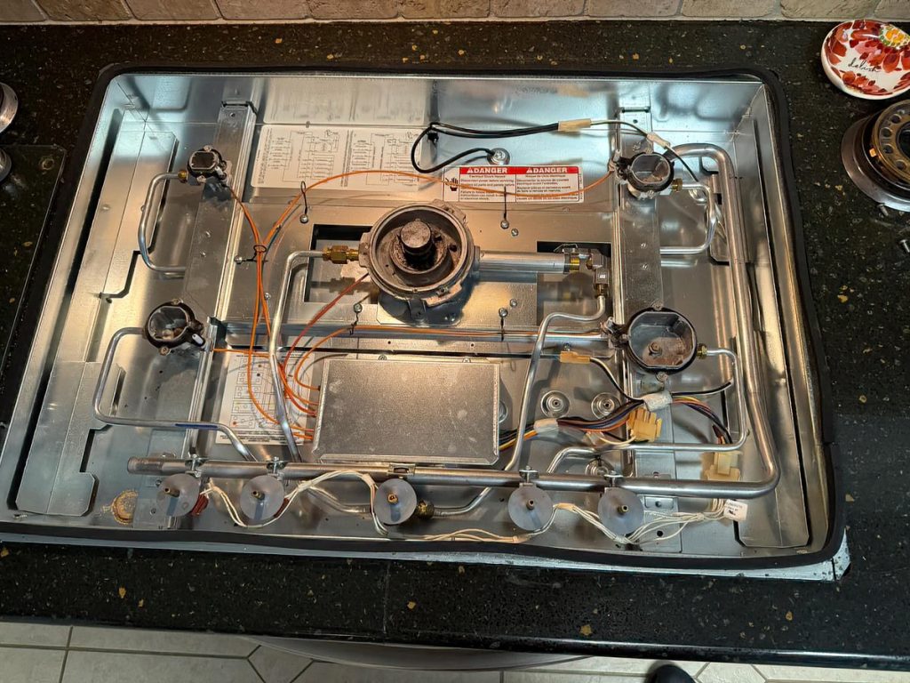 Inside the Kitchenaid Cooktop with the top cover removed.